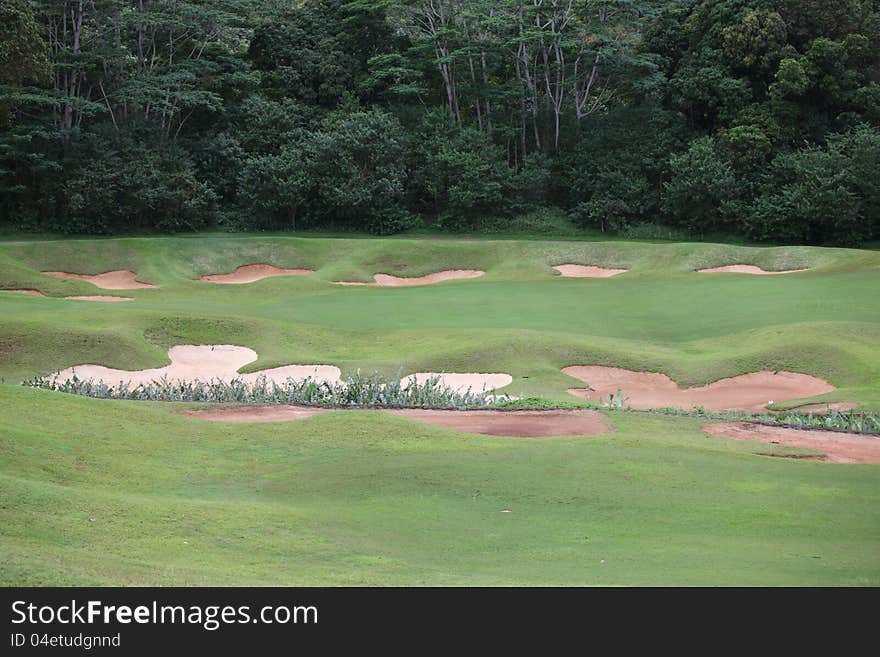 Bunker traps around green at country golf course, Oahu, Hawaii. Bunker traps around green at country golf course, Oahu, Hawaii