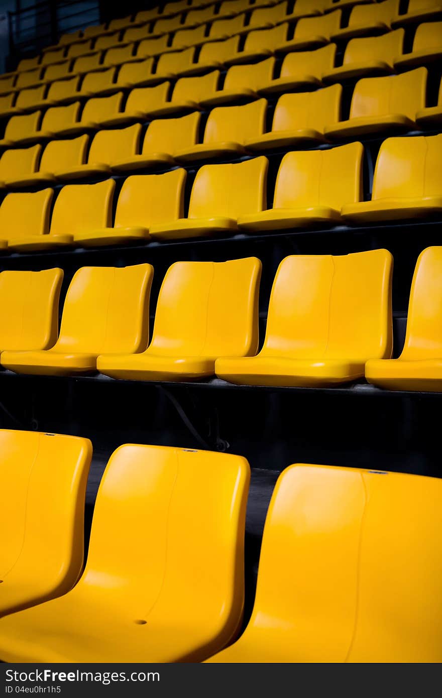 Rows pf empty yellow seats in the stadium