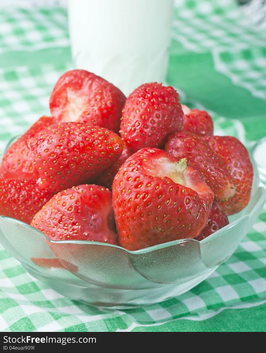 Strawberries in a glass bowl on table