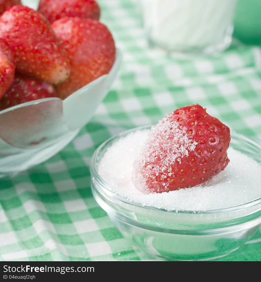 Strawberries and sugar on table. Strawberries and sugar on table