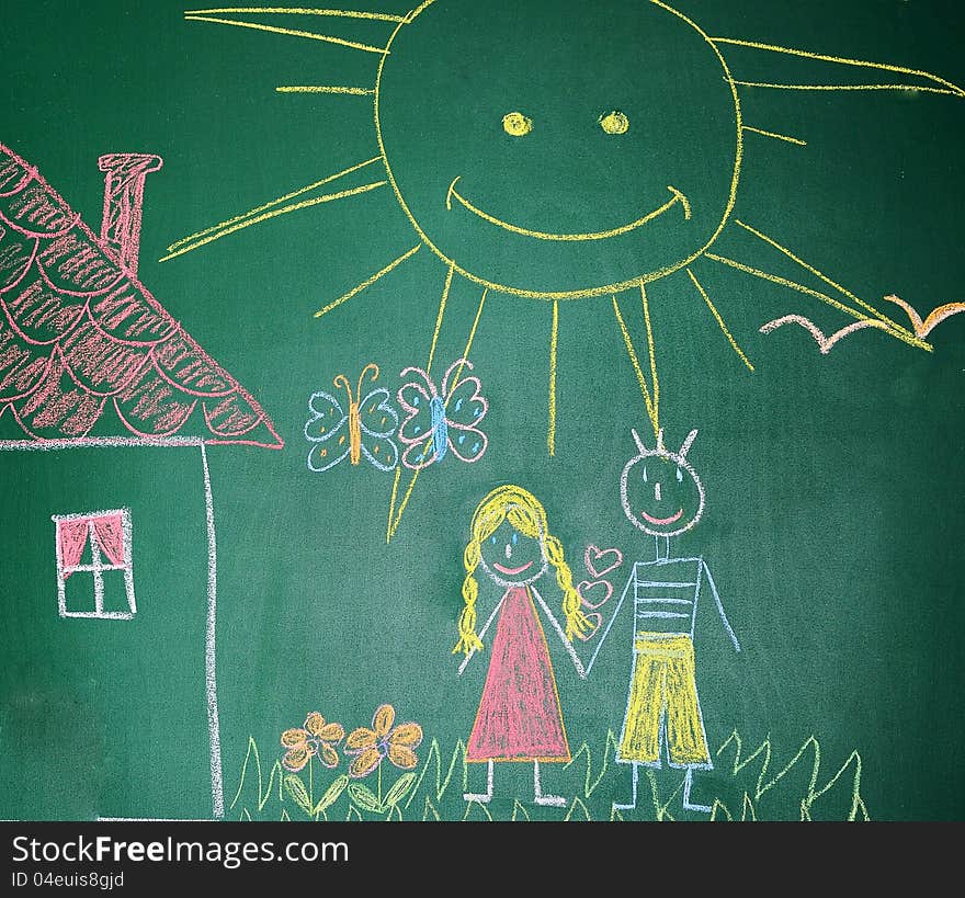 Blackboard with drawing happy couple  with house closeup