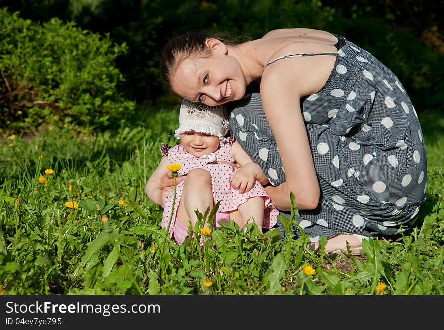 Woman and child sits on the grass