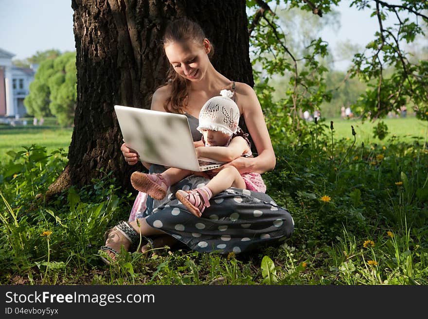 Woman with child and laptop