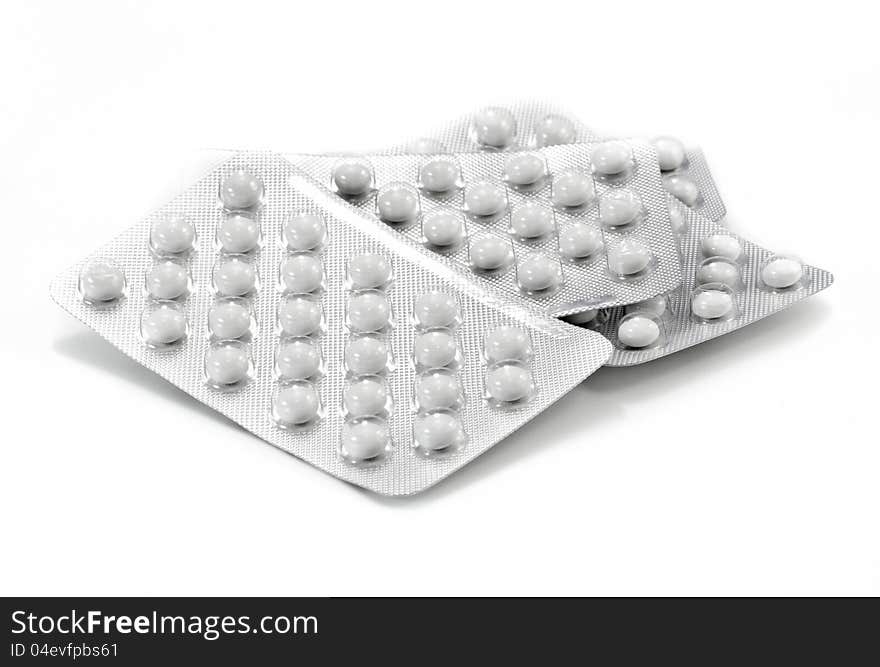 White pills on white background