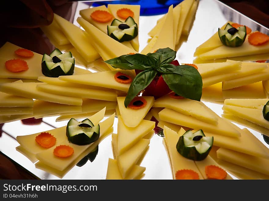 Cheese platter with carrots and cucumber.