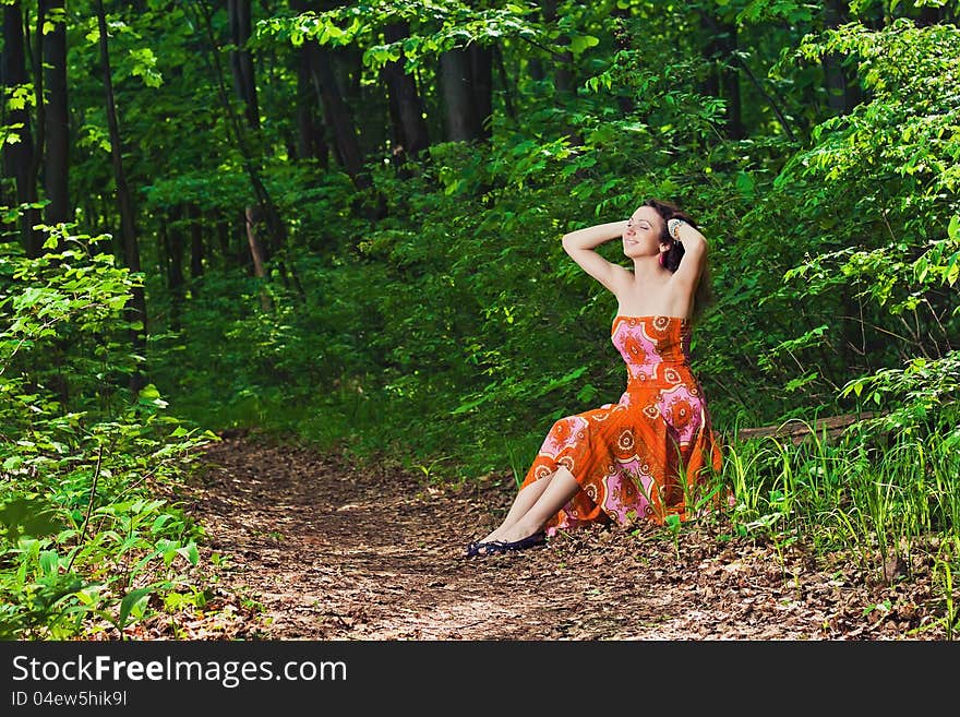 Woman sitting in forest