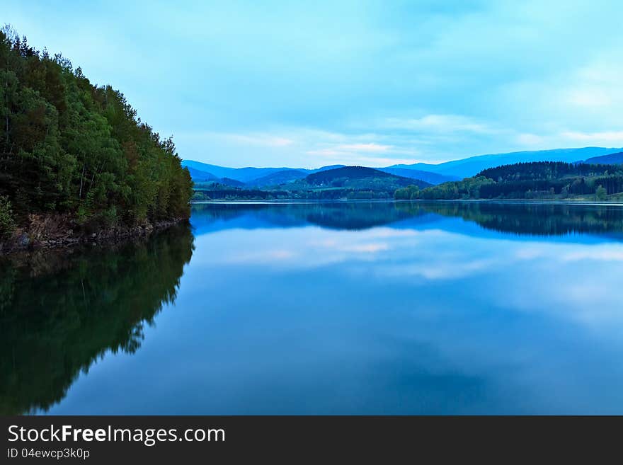 This was beautiful early spring ideally constructed for shooting dusk, mountains (Bohemian Forest) afar and water in the Nyrsko lake in the same quit blue color. This was beautiful early spring ideally constructed for shooting dusk, mountains (Bohemian Forest) afar and water in the Nyrsko lake in the same quit blue color.