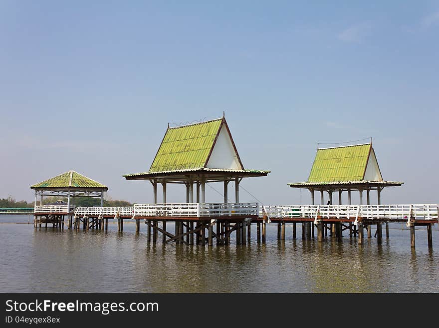 Pavilion Thai has three green roofs on the water and walk to the white connector.Generally in Thailand, any kind of art decorated in Buddhist church, temple pavilion, temple hall, monkâ€™s house etc. creaced with money donated by people to hire artist. They are public domain or treasure of Buddhism, no restrict in copy or use, no name of artist appear (but, if there is artist name, it only for tel. Pavilion Thai has three green roofs on the water and walk to the white connector.Generally in Thailand, any kind of art decorated in Buddhist church, temple pavilion, temple hall, monkâ€™s house etc. creaced with money donated by people to hire artist. They are public domain or treasure of Buddhism, no restrict in copy or use, no name of artist appear (but, if there is artist name, it only for tel