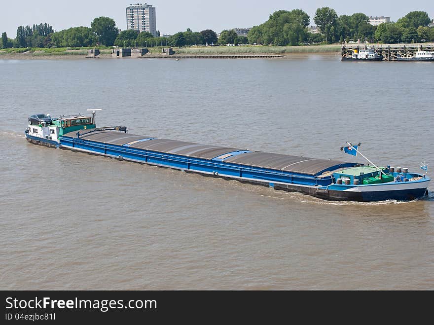 Big barge on scheldt river in antwerp, Belgium. A car on it. Big barge on scheldt river in antwerp, Belgium. A car on it.