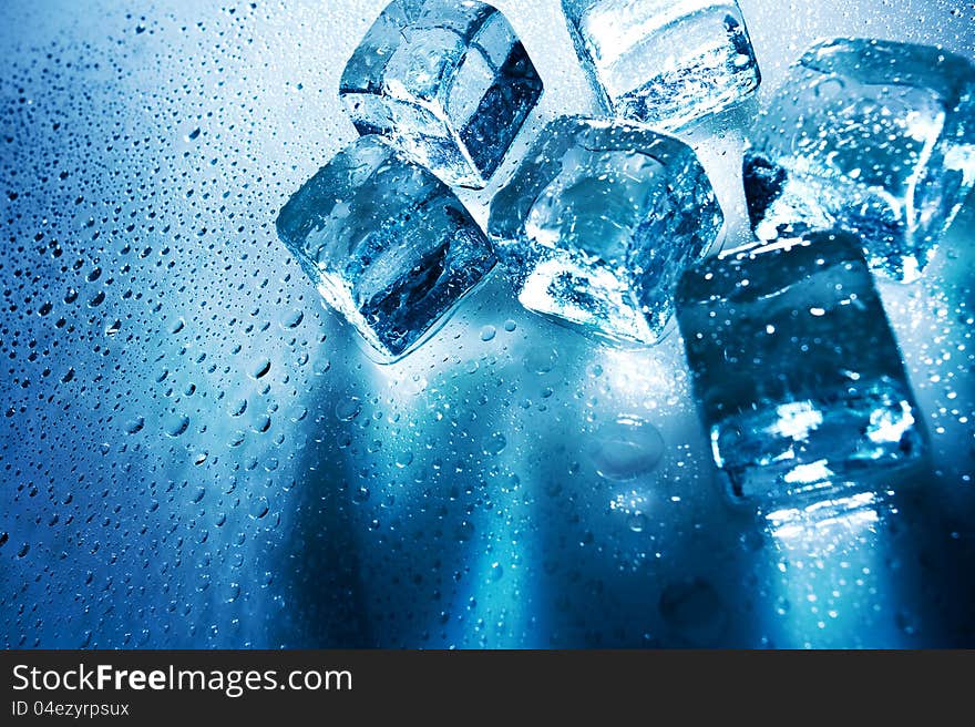 Ice cubes over wet backgrounds with back light