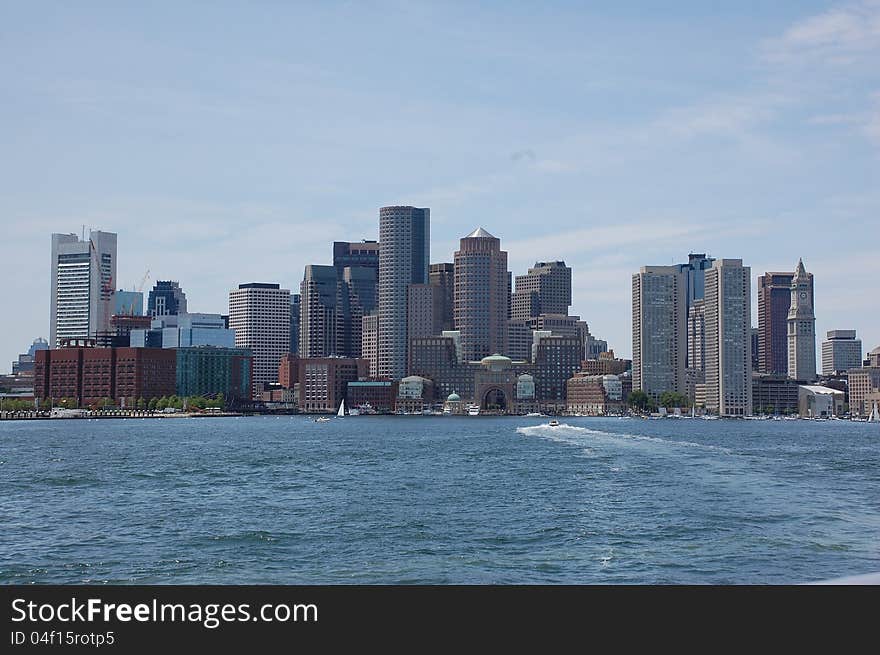 Boston skyline as seen from a boat sailing into the harbor