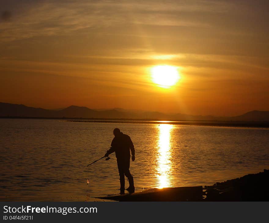 Fisherman On The Sunset