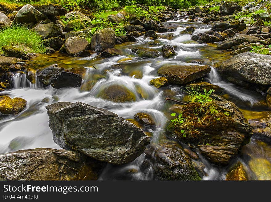 Picture a mountain river flowing among stones