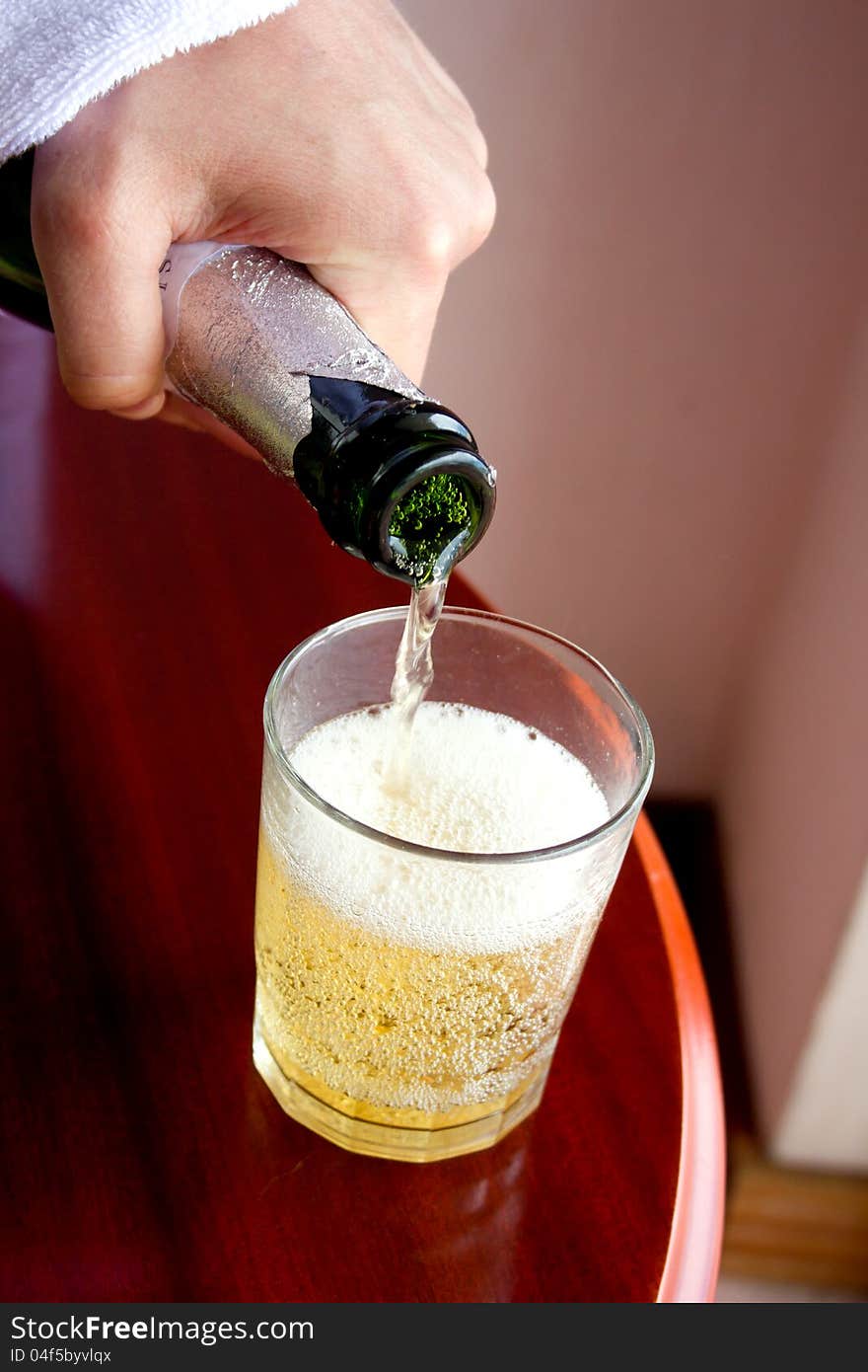 Pouring cider into the glass, apple cider, glass on the table. Pouring cider into the glass, apple cider, glass on the table