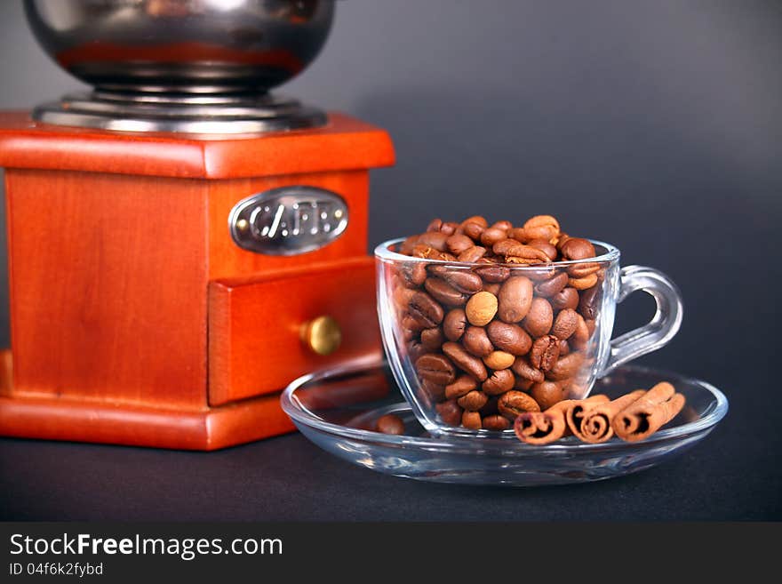 Vintage coffee grinder with a cup of beans. Vintage coffee grinder with a cup of beans