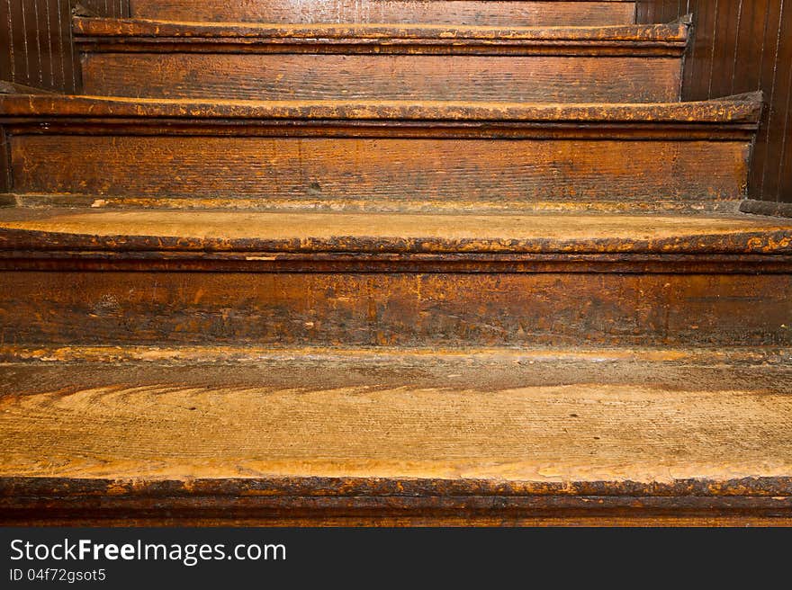 Old, well-worn wooden steps ascending. Old, well-worn wooden steps ascending