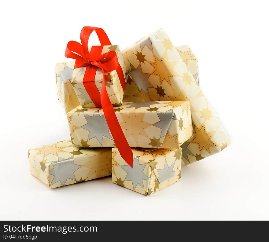 Stack of Gift Boxes and one with Red Satin Ribbon Bow isolated on white background. Stack of Gift Boxes and one with Red Satin Ribbon Bow isolated on white background