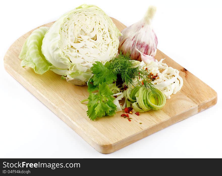 Set of cabbage and raw vegetables close up on wooden background