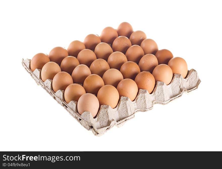 Carton of fresh brown eggs on white background