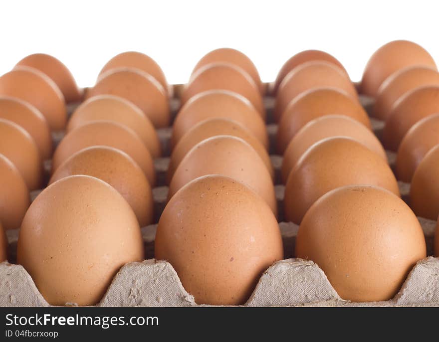 Carton of fresh brown eggs on white background