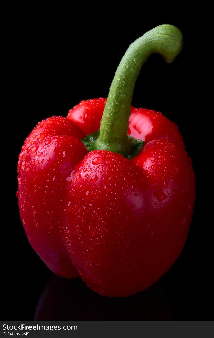 Red pepper isolated on black background .