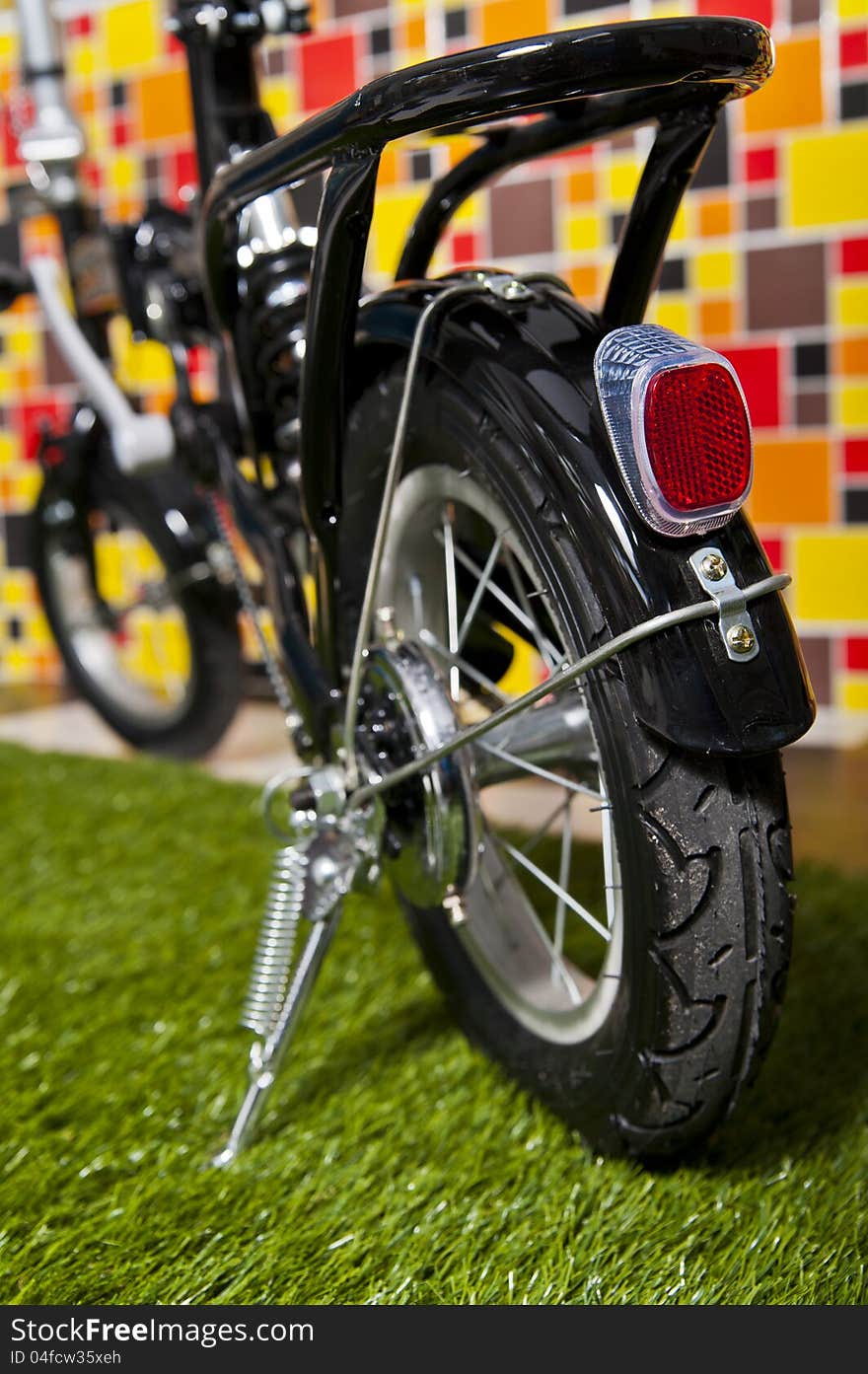 Black small bicycle on colorful background