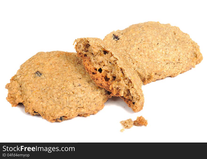 Crispy homemade raisin oatmeal cookies with crumbs  on a white background