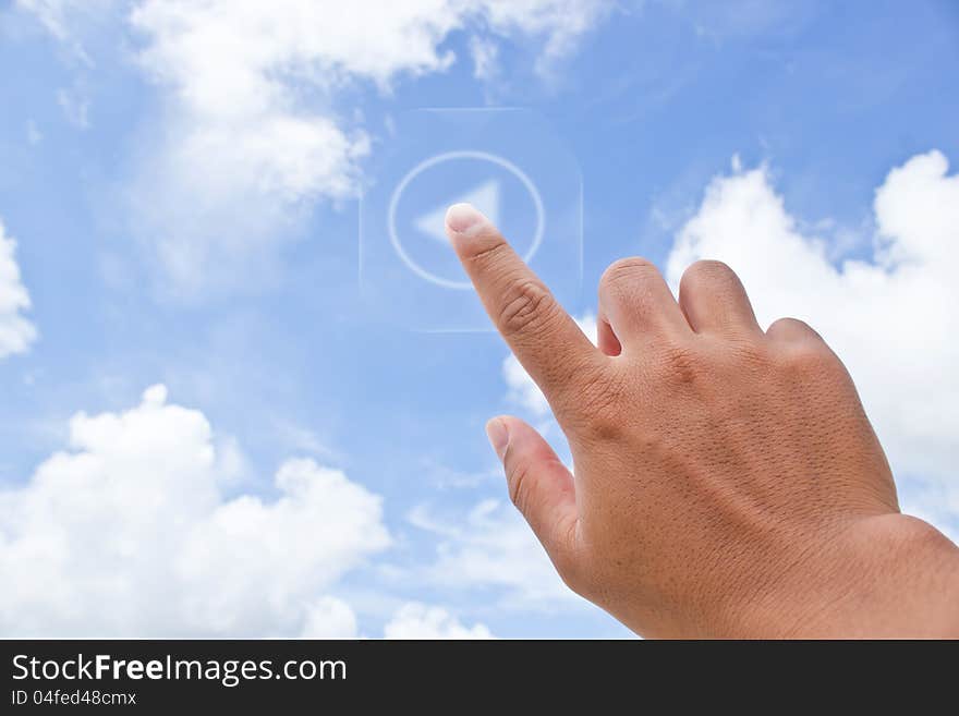 Hand pressing button with Sky background