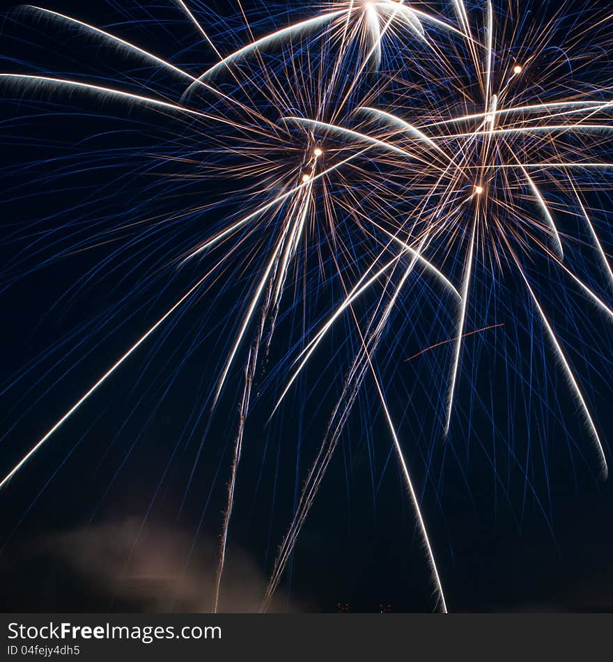 Colorful fireworks over dark sky, displayed during a celebration