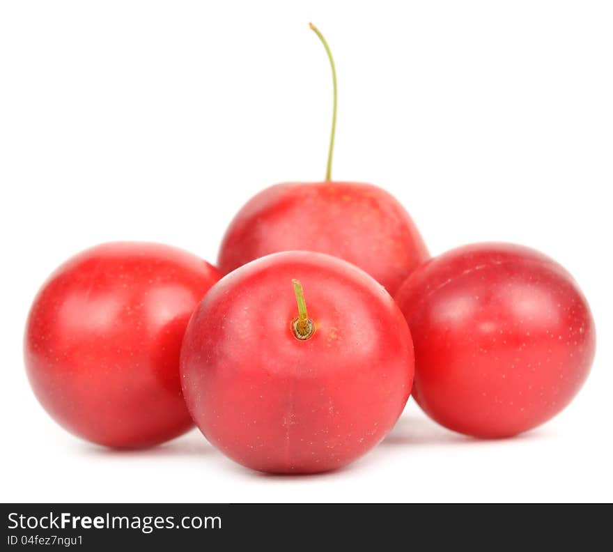 Red cherry plums on a white background