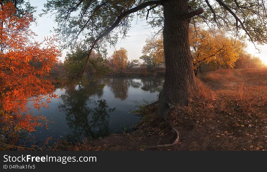 Beautiful autumn landscape on coast of the river, foggy morning with sun. Panorama. Beautiful autumn landscape on coast of the river, foggy morning with sun. Panorama