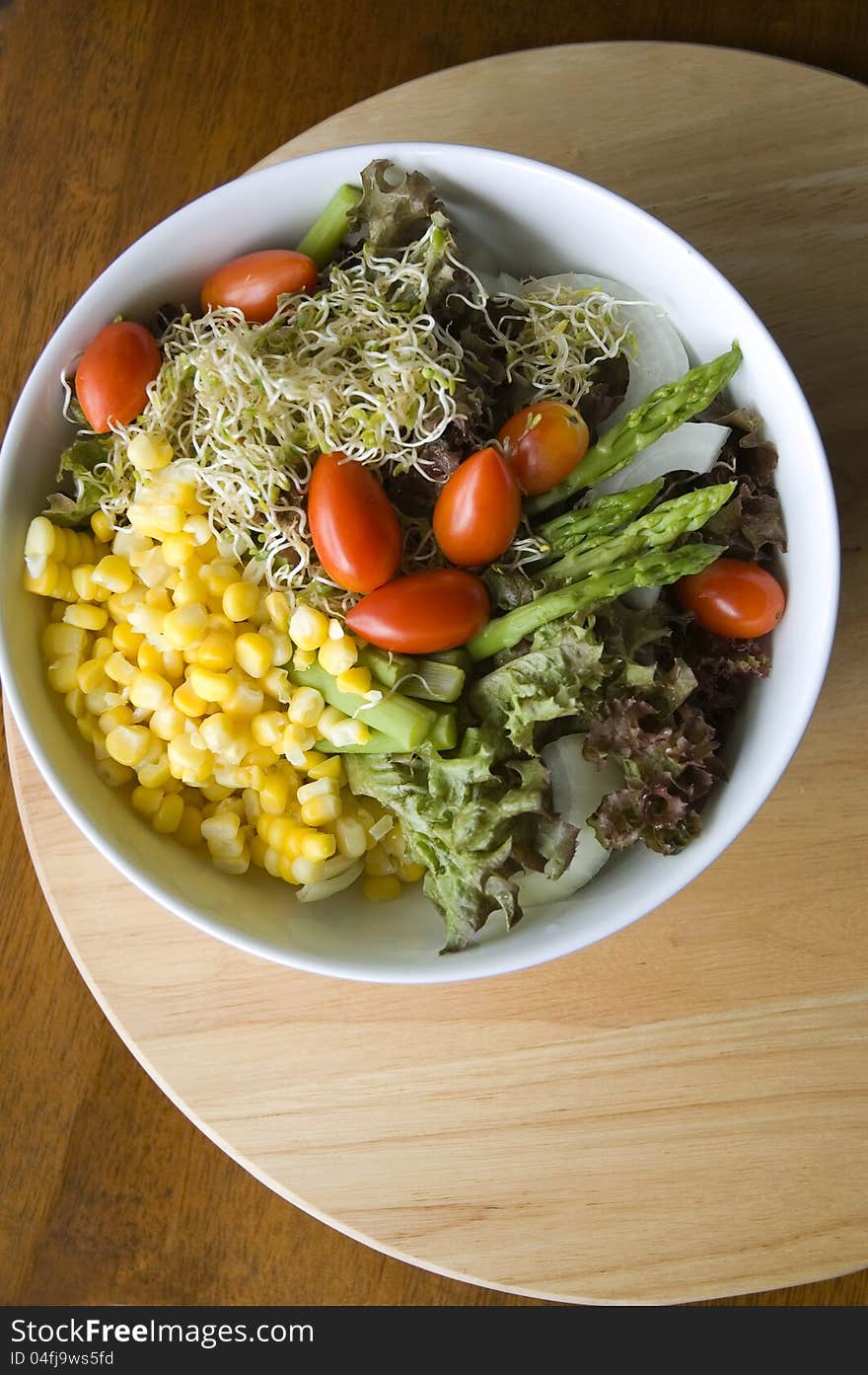 Mixed salad bowl on wood