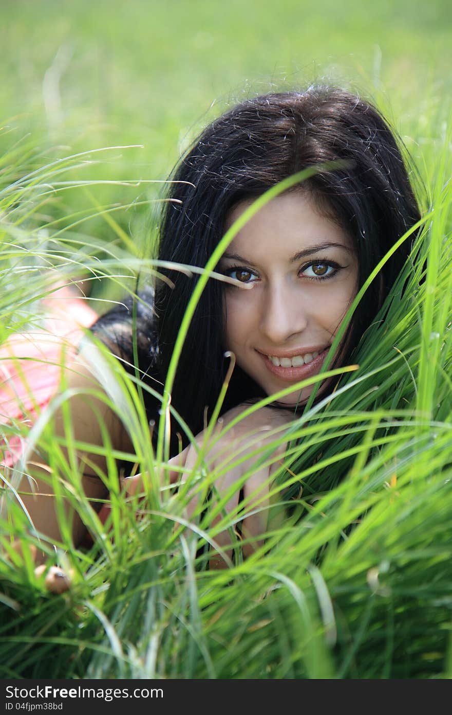 Beautiful young woman lying on grass