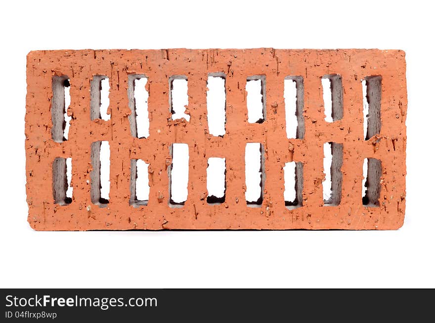 A red perforated brick on a white background - horizontal orientation