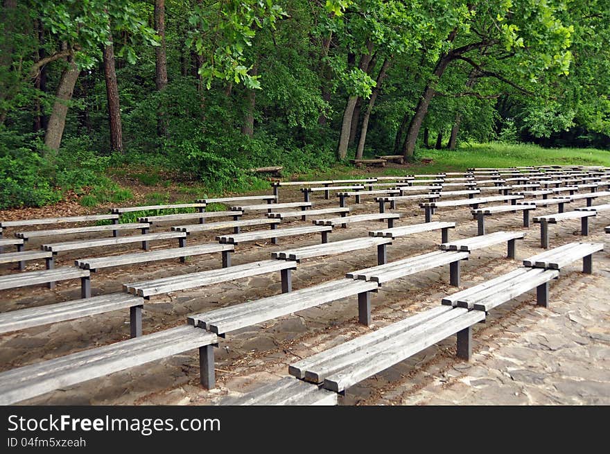 Bench on alley in a park near forest. Bench on alley in a park near forest