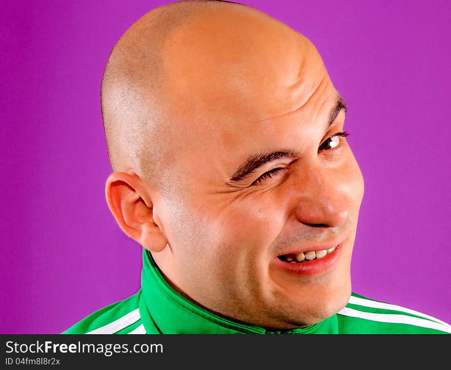 Man winking isolated on purple