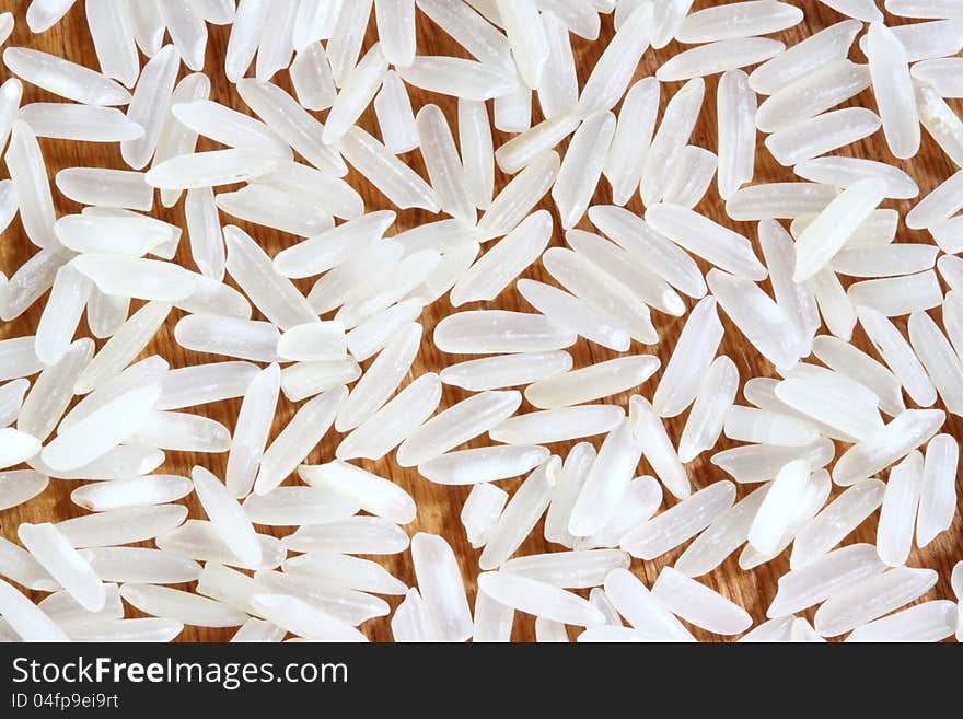 White long white rice in wooden background