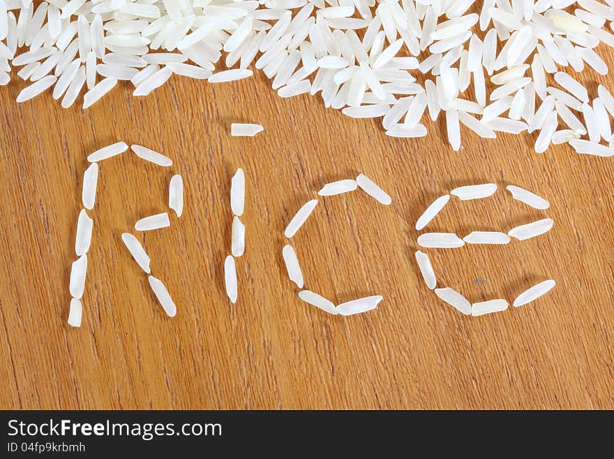 White long white rice on wooden background