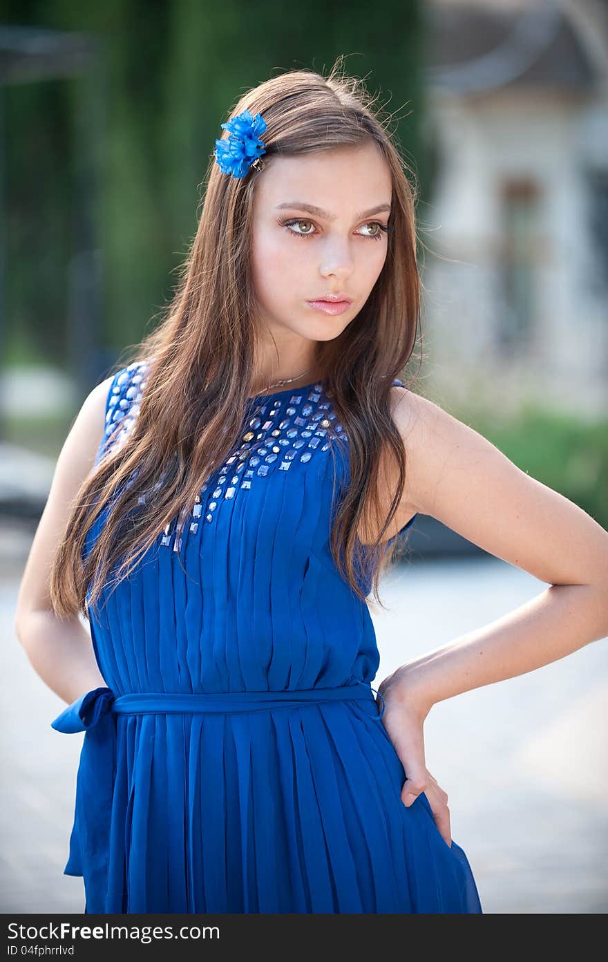 Portrait of beautiful fresh teenager girl with expressive look posing on a background of flowerbeds. Portrait of beautiful fresh teenager girl with expressive look posing on a background of flowerbeds