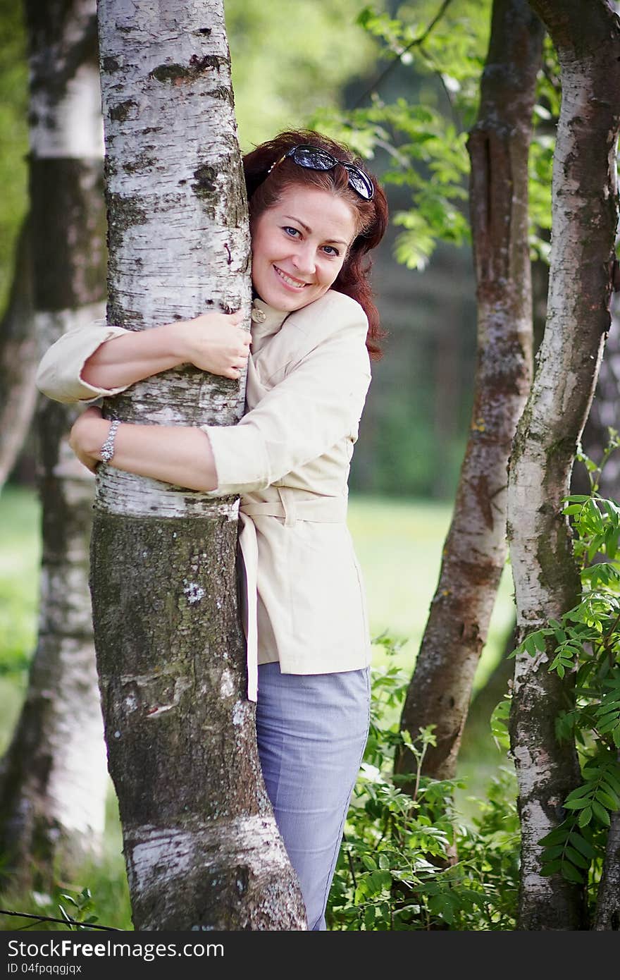 Woman embracing a birch