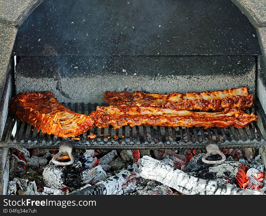 BBQ pork ribs on outdoor grill. BBQ pork ribs on outdoor grill