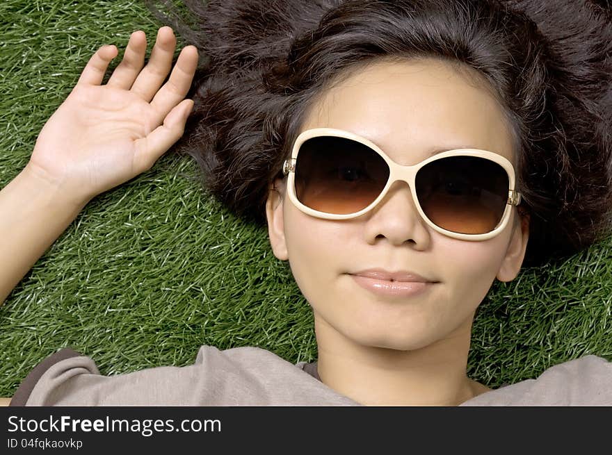 Woman laying on the green grass on the summer. Woman laying on the green grass on the summer