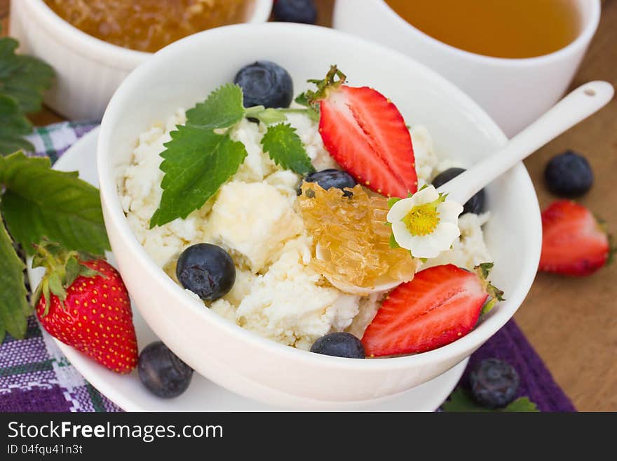 Dietary cottage cheese with honey, blueberries and strawberry. Dietary cottage cheese with honey, blueberries and strawberry