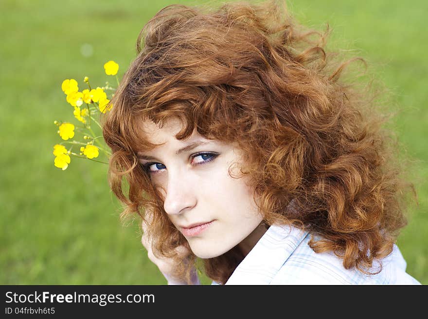 Summer image of cute young woman with flower, close up