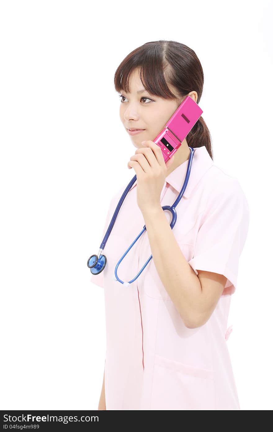 Young asian female nurse calling by cellular phone