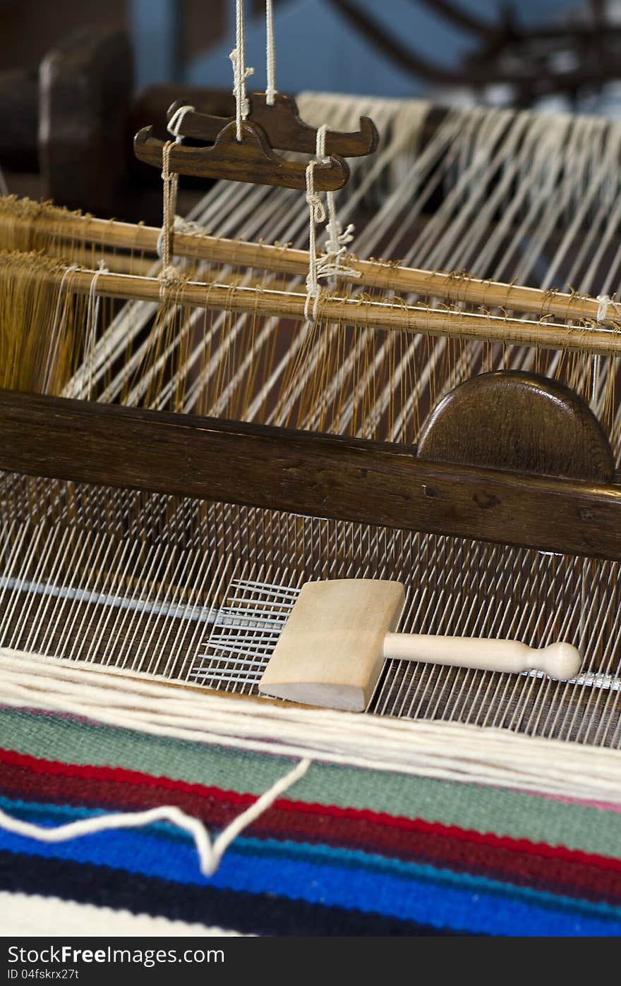 Manual loom with a rug being made