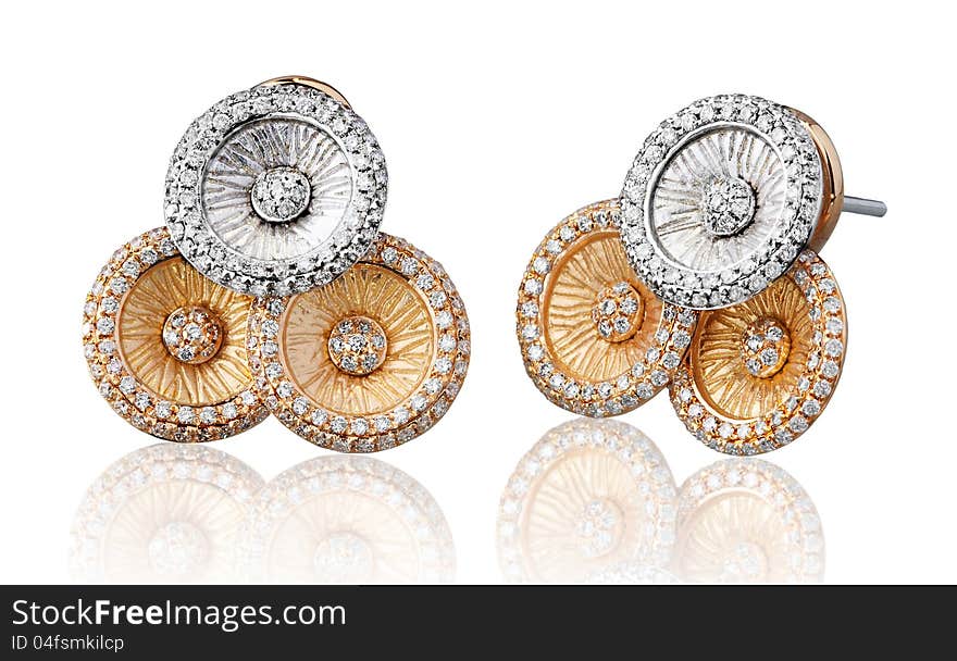 Silver and gold earrings decorated by diamonds