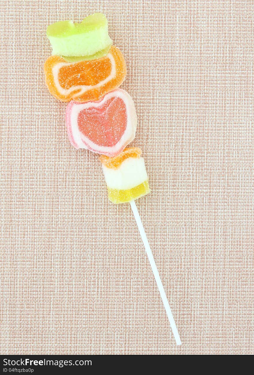 Colorful jelly candy stick on fabric