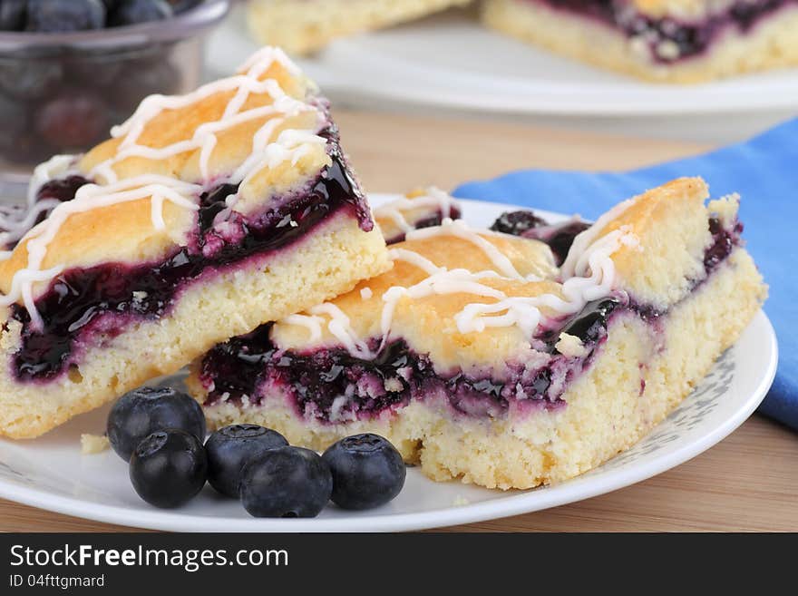 Closeup of two blueberry bars with berries on a plate. Closeup of two blueberry bars with berries on a plate