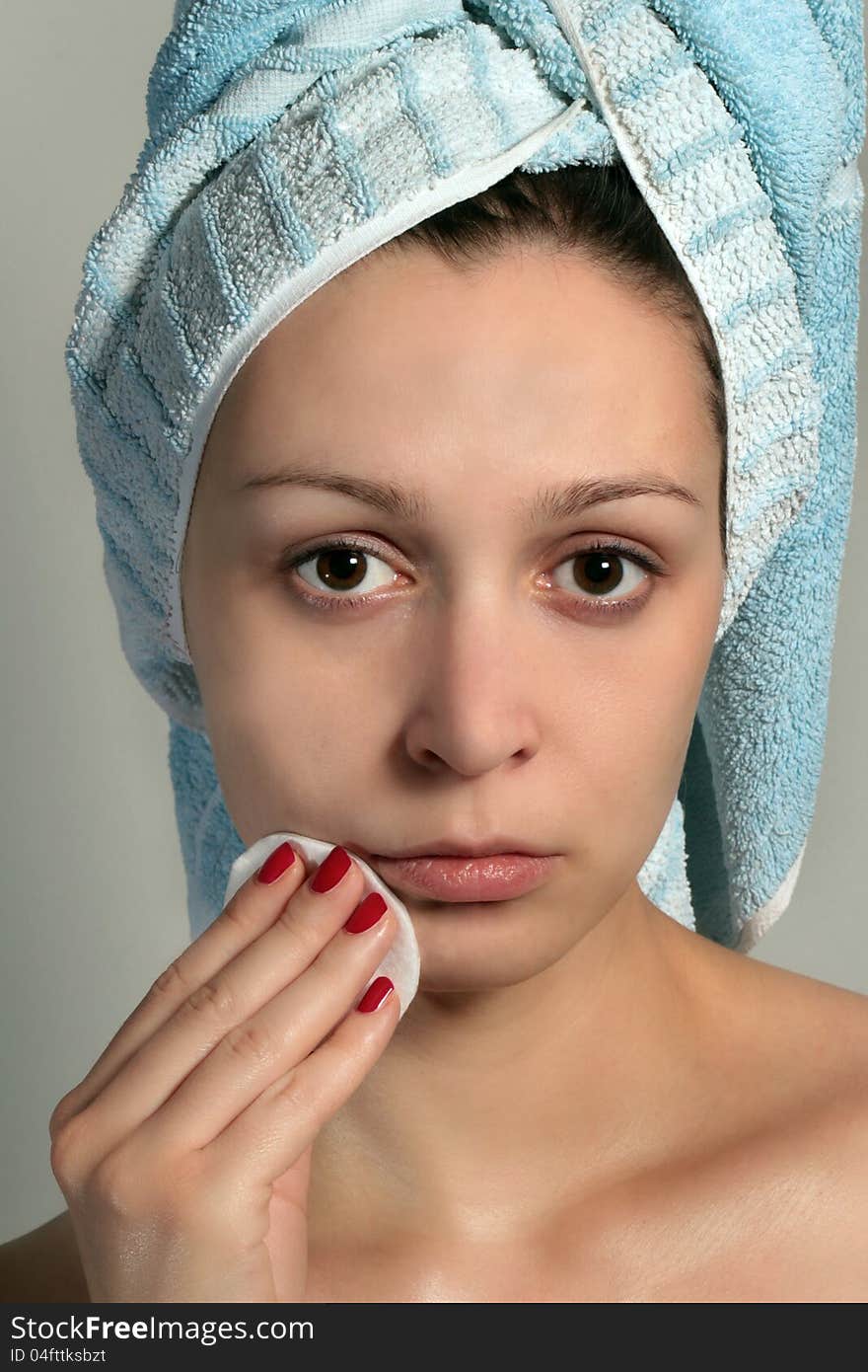 Close up of pretty woman removing makeup with cotton pad - skin care concept. Close up of pretty woman removing makeup with cotton pad - skin care concept.